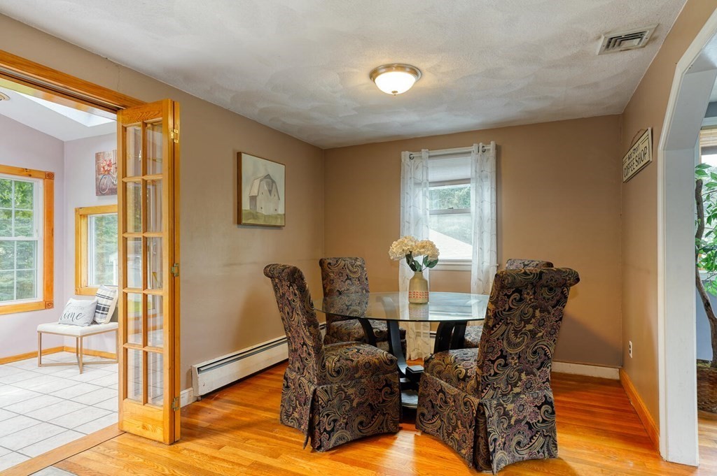 16 Lasallette Road, Unit 16 Billerica, MA 01821 - Photo 6 of 27 a view of a dining room with furniture and wooden floor