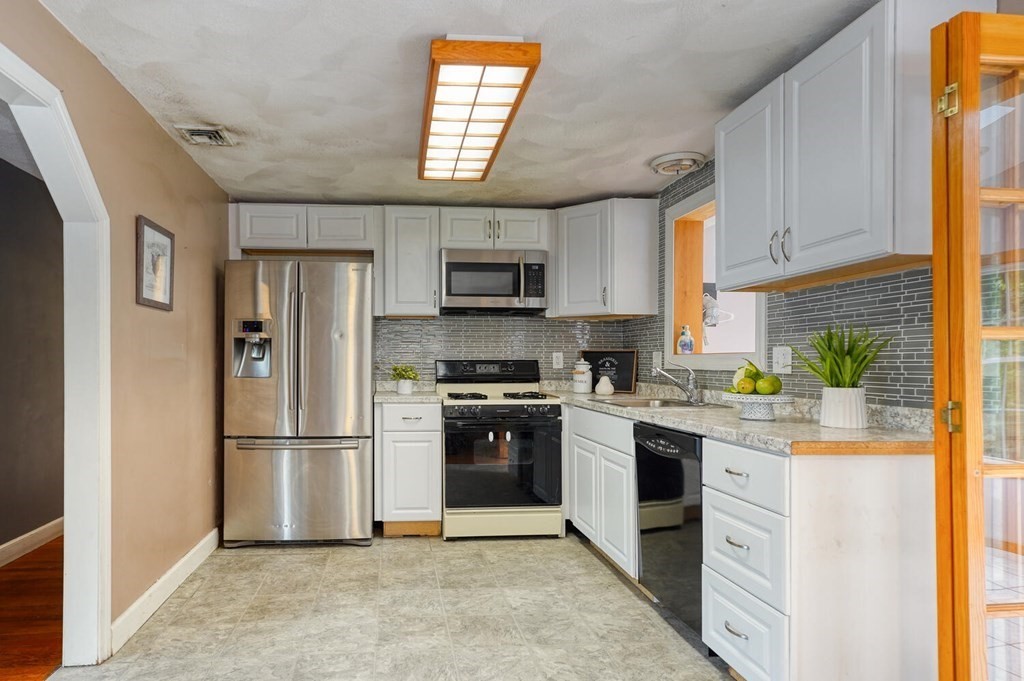 16 Lasallette Road, Unit 16 Billerica, MA 01821 - Photo 7 of 27 a kitchen with stainless steel appliances granite countertop a refrigerator sink and stove