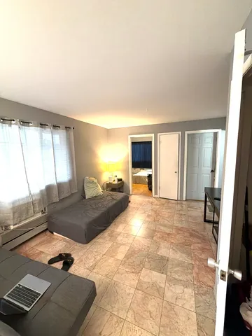 a bedroom with a bed and a large mirror