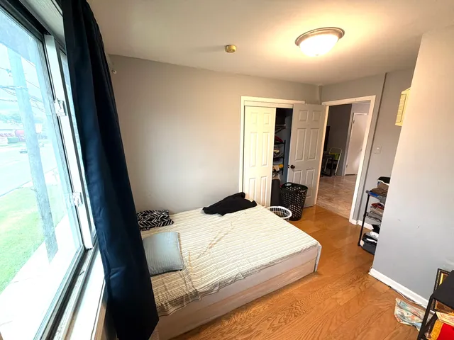 a kitchen with stainless steel appliances a refrigerator a sink and white cabinets