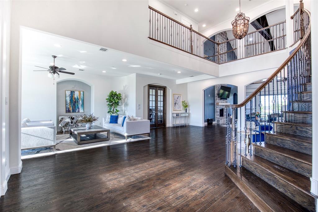901 Inverness Court Lucas, TX 75002 - Photo 5 of 40 Foyer featuring arched walkways, hardwood / wood-style floors, hanging lights, a high ceiling, and a ceiling fan