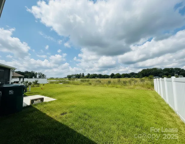 a view of house with yard