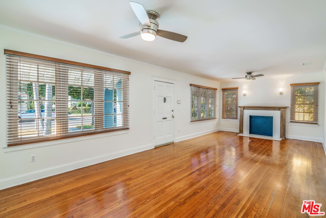 2832 Virginia Road Los Angeles, CA 90016 - Photo 3 of 14 a view of an empty room with wooden floor fireplace and a window