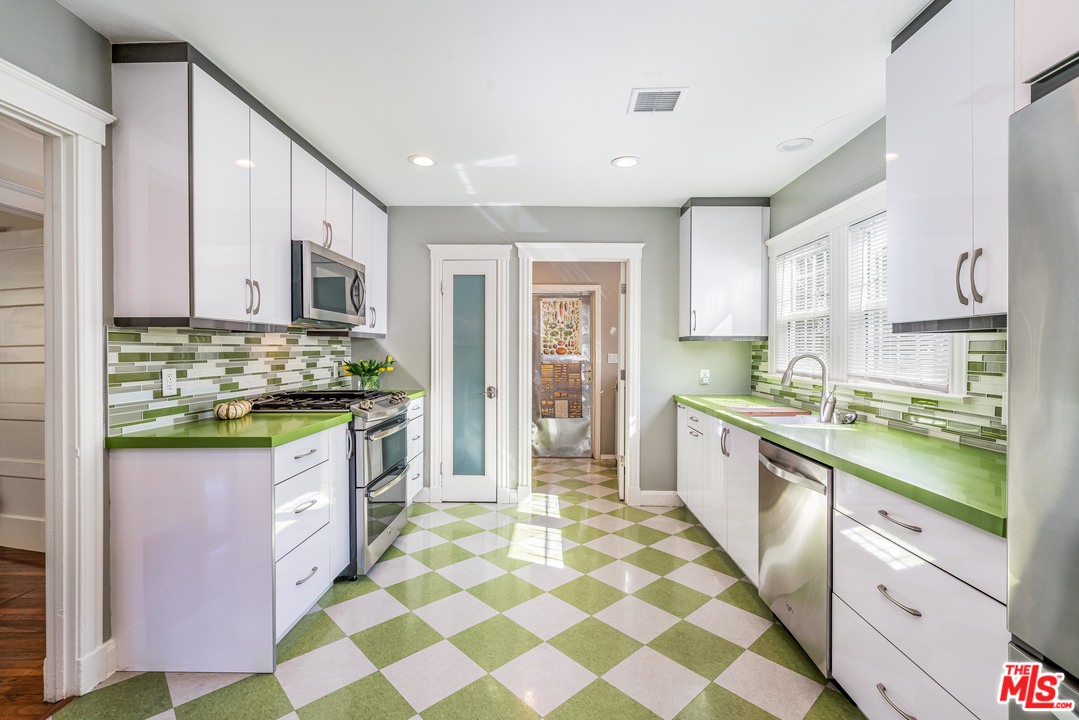 2832 Virginia Road Los Angeles, CA 90016 - Photo 4 of 14 a large kitchen with stainless steel appliances a stove a sink and a refrigerator