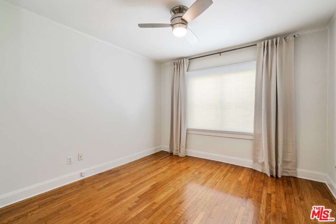 2832 Virginia Road Los Angeles, CA 90016 - Photo 9 of 14 an empty room with wooden floor and windows