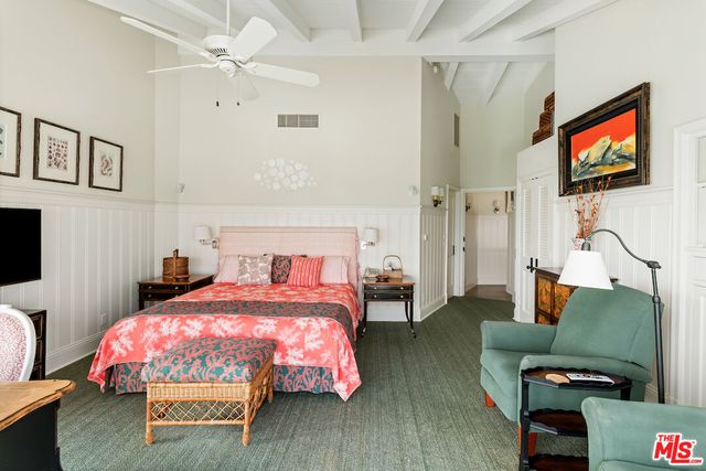 a bathroom with a granite countertop sink a mirror and shower