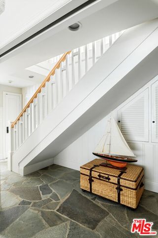 a bathroom with a granite countertop sink and mirror