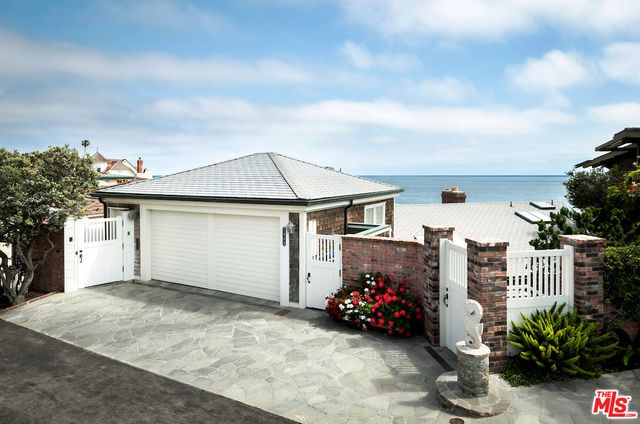 a view of a patio with couches table and chairs and potted plants