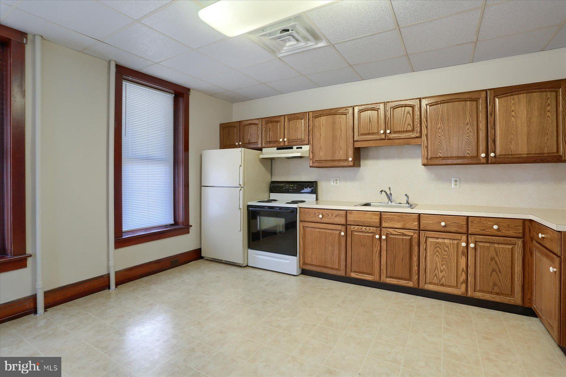 50 East Maple Street, Unit 4 Palmyra, PA 17078 - Photo 11 of 22 a kitchen with stainless steel appliances granite countertop a stove a sink dishwasher and a refrigerator