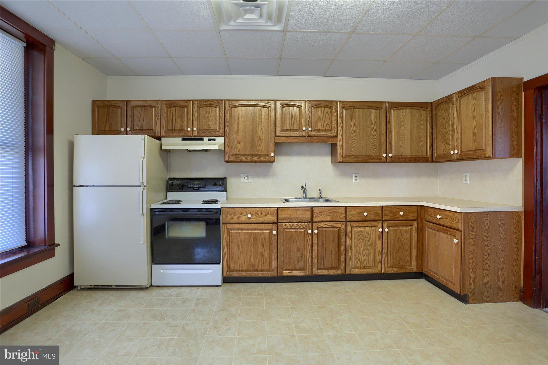 50 East Maple Street, Unit 4 Palmyra, PA 17078 - Photo 12 of 22 a kitchen with stainless steel appliances granite countertop a refrigerator a stove a sink and dishwasher