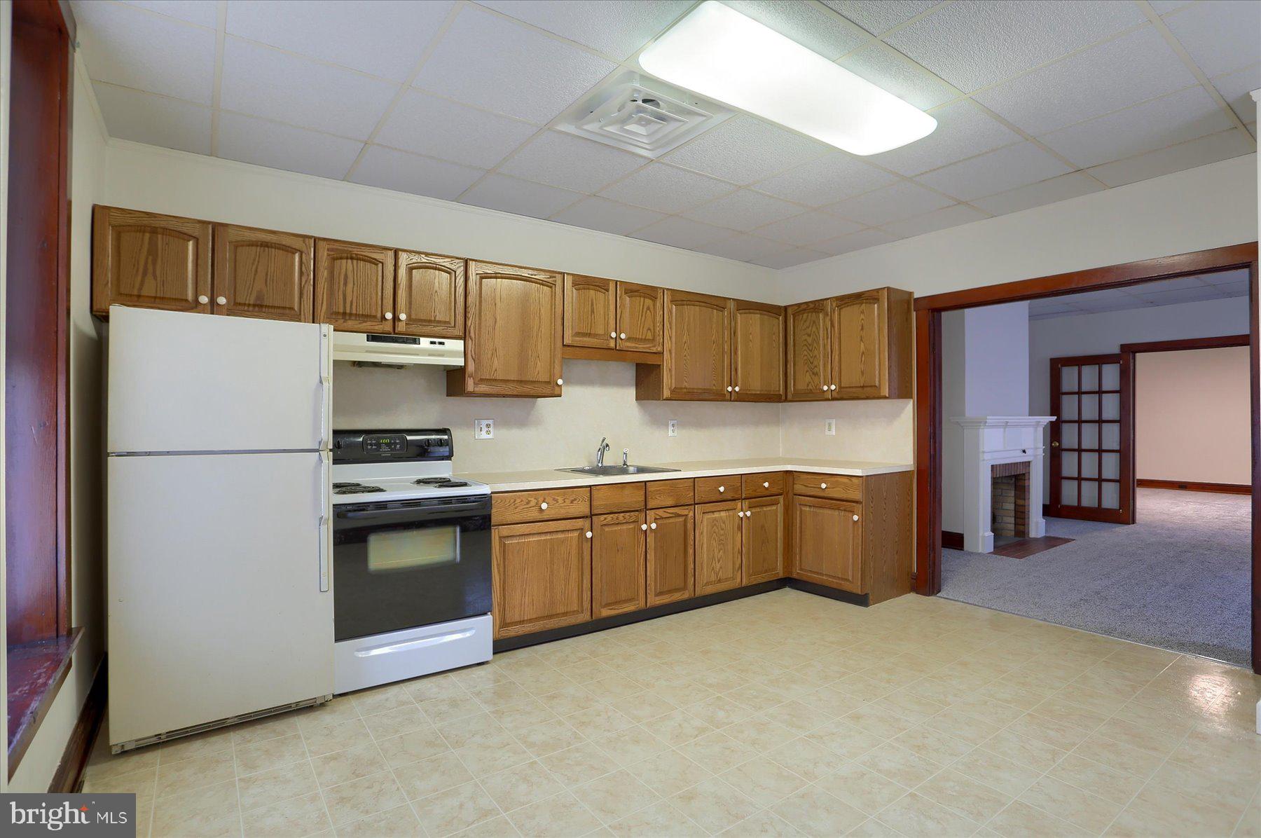 50 East Maple Street, Unit 4 Palmyra, PA 17078 - Photo 13 of 22 a kitchen with stainless steel appliances granite countertop a refrigerator a stove top oven a sink and dishwasher
