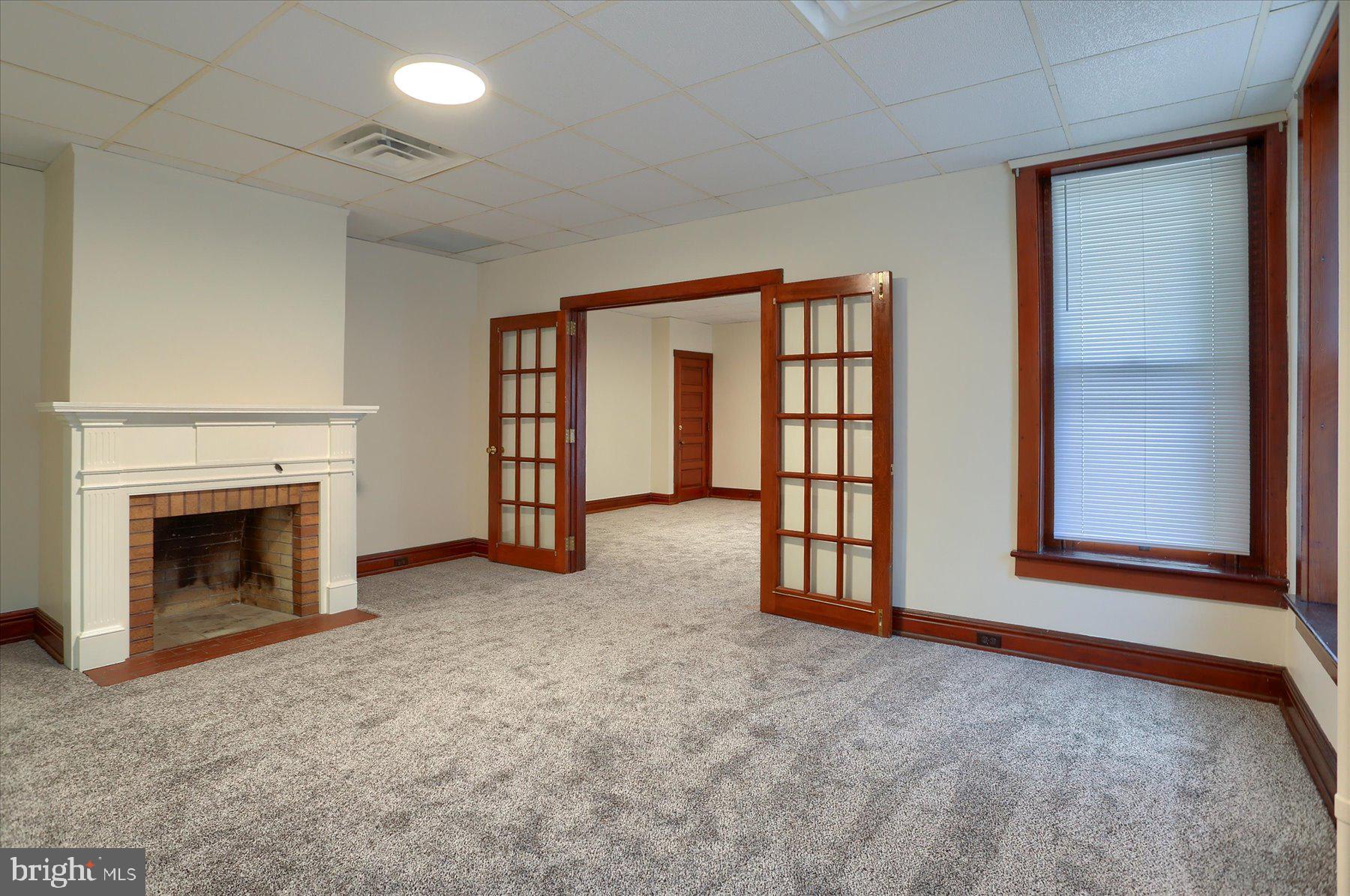 50 East Maple Street, Unit 4 Palmyra, PA 17078 - Photo 7 of 22 a view of an empty room with a fireplace and a window