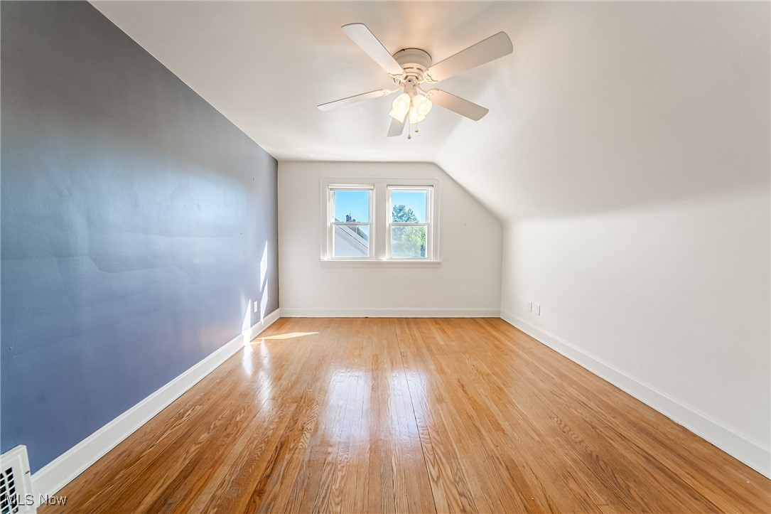 6711 Forest Avenue Parma, OH 44129 - Photo 23 of 33 Additional living space with light wood-type flooring, vaulted ceiling, and ceiling fan