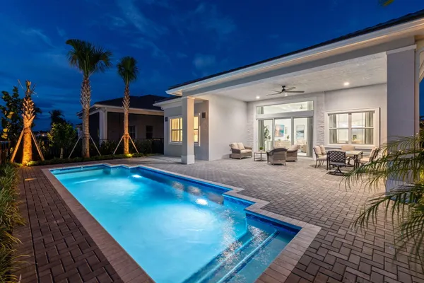 a view of a swimming pool with outdoor seating