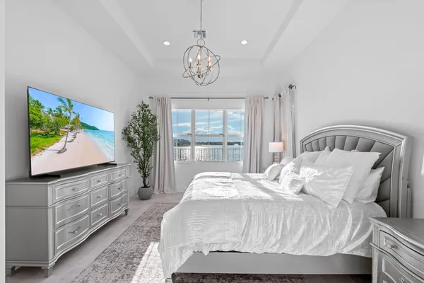 a bedroom with a bed and flat screen tv