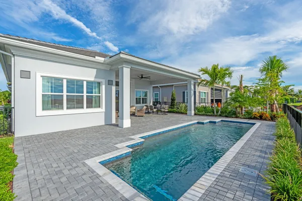 a view of a house with backyard and porch