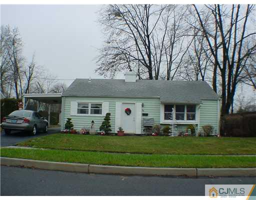 64 Stony Road Edison, NJ 08817 - Photo 1 of 2 a front view of a house with a garden and trees