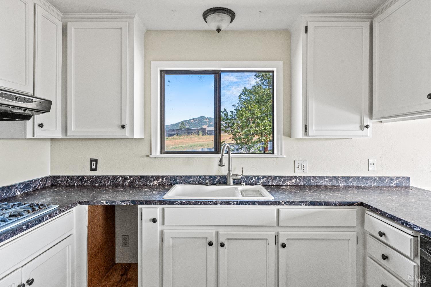 3850 Rd B Redwood Valley, CA 95470 - Photo 12 of 35 a kitchen with granite countertop a sink stainless steel appliances white cabinets and a granite counter tops