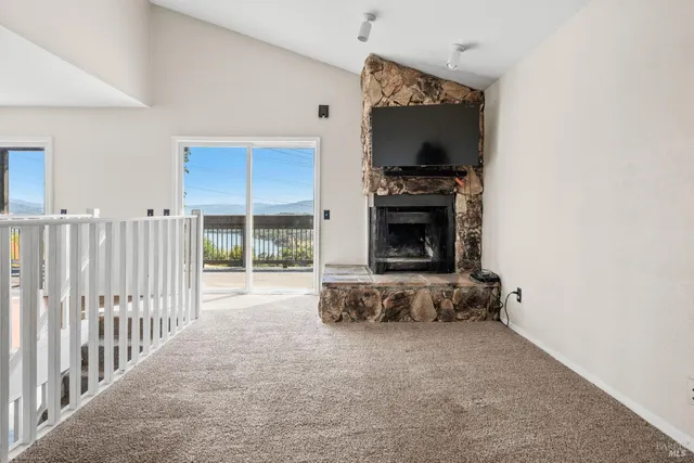 a view of a livingroom with fireplace and furniture