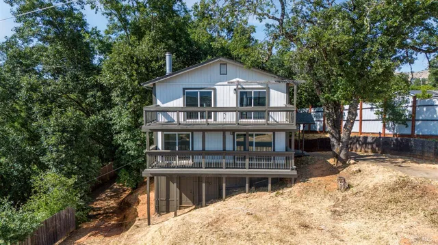 a front view of a house with a yard garage and outdoor seating