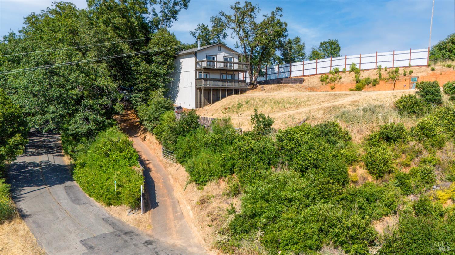 3850 Rd B Redwood Valley, CA 95470 - Photo 33 of 35 a view of a house with a small yard and large trees