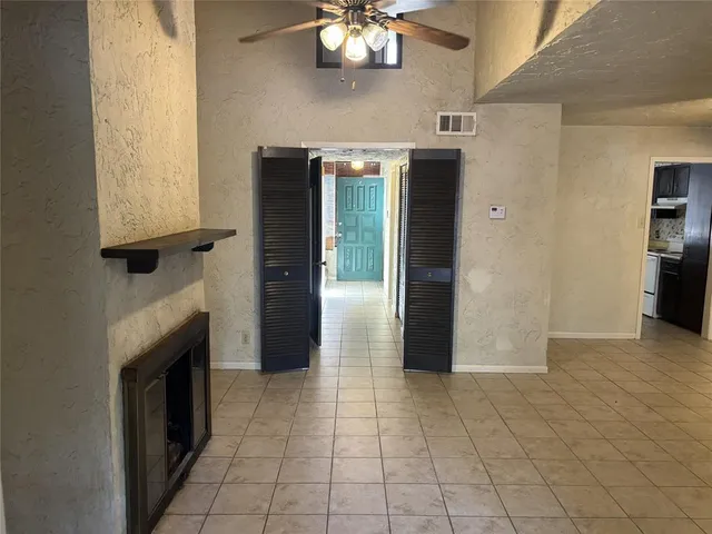 a view of an empty room with a fireplace