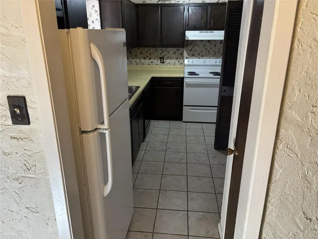 a kitchen with a refrigerator and a stove