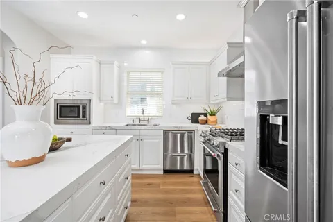 a kitchen with a sink stove and refrigerator