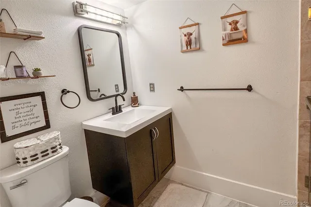 a bathroom with a sink toilet and mirror