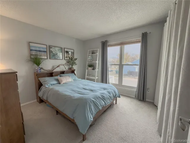 a bedroom with a large bed and a large window