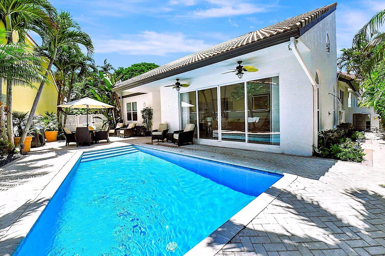 3567 Commodore Circle Delray Beach, FL 33483 - Photo 49 of 76 a view of a house with swimming pool and sitting area