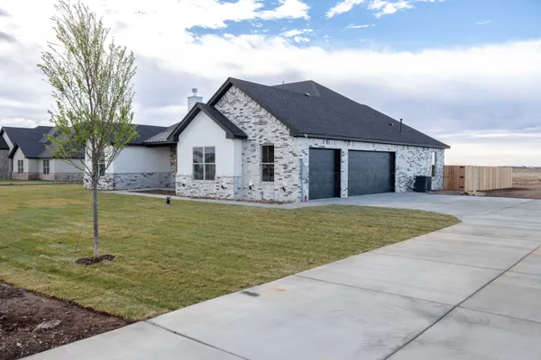 a view of a house with swimming pool next to a yard