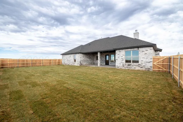 a view of a house with a yard and ocean view