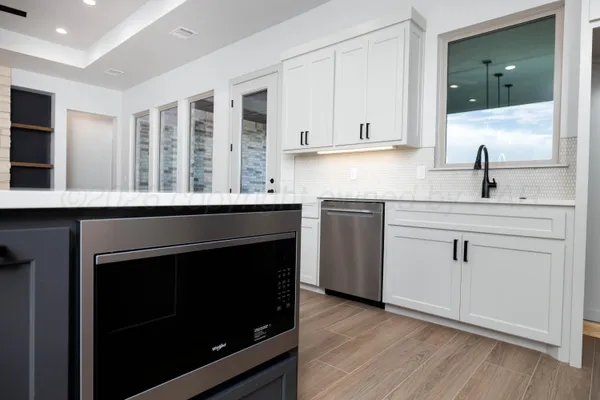 a kitchen with a sink stove and cabinets