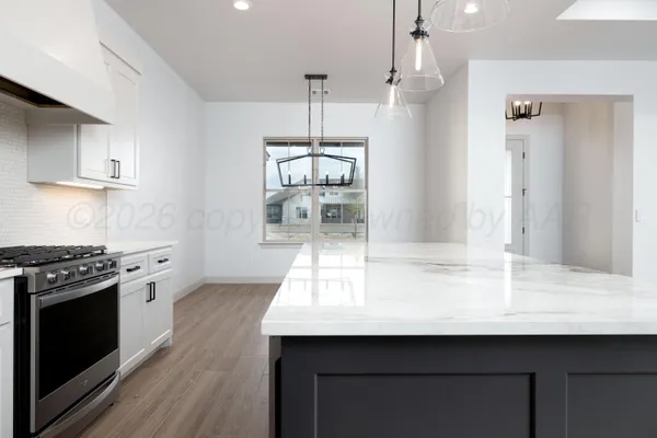 a kitchen with a sink stainless steel appliances and window
