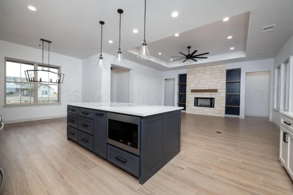 a kitchen with stainless steel appliances granite countertop a stove and a wooden floors