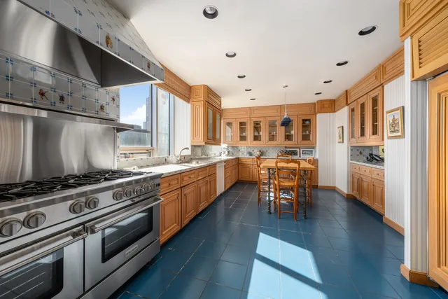 a kitchen with stainless steel appliances granite countertop a stove and a refrigerator
