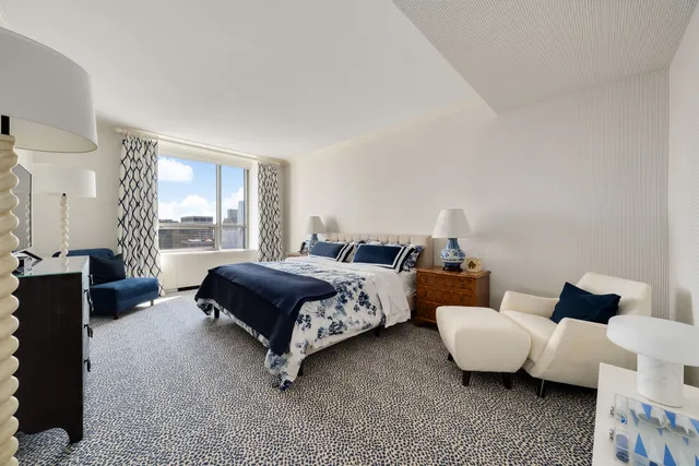 a spacious bathroom with a double vanity sink and a large mirror