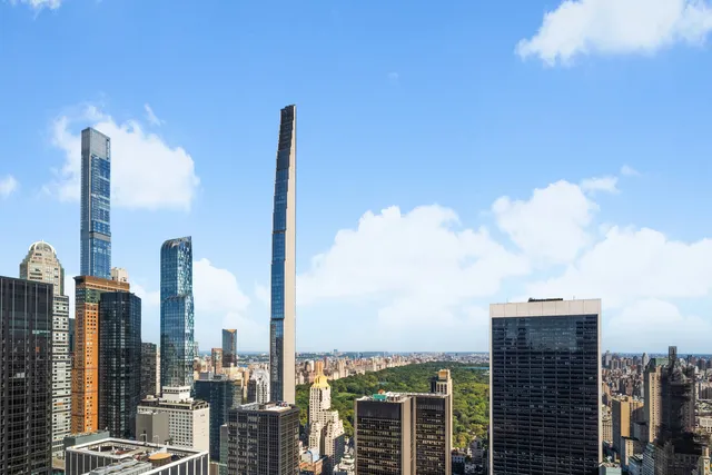 a spacious bedroom with a bed and a large window