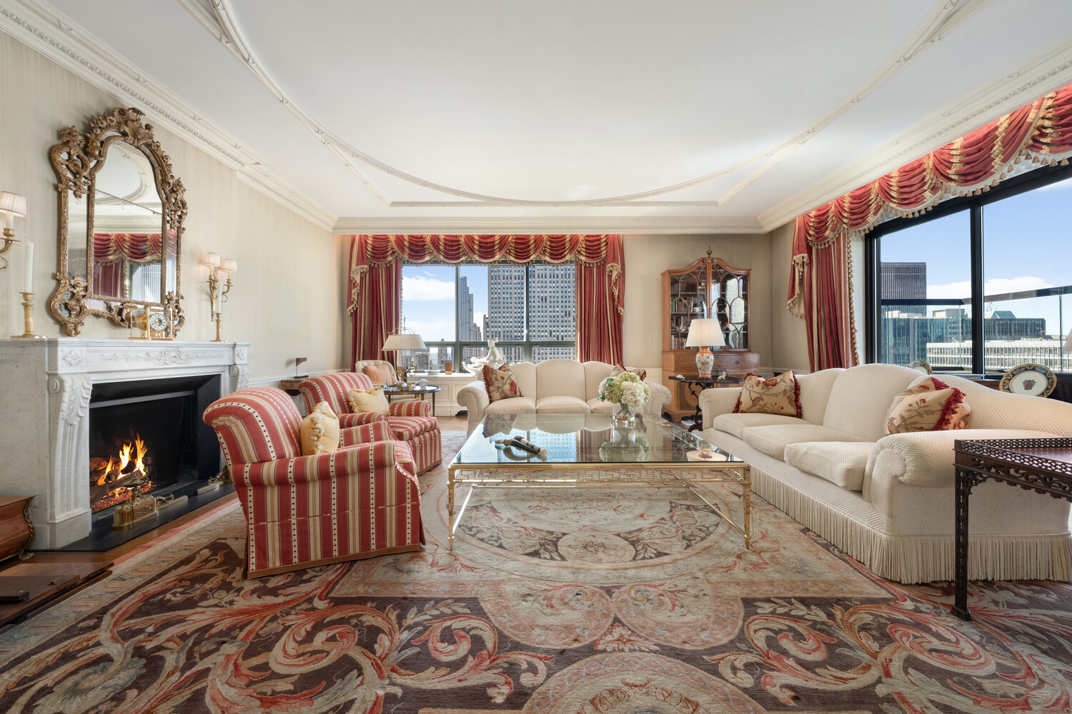 15 West 53rd Street, Unit PH Manhattan, NY 10019 - Photo 4 of 28 a living room with furniture and a fireplace