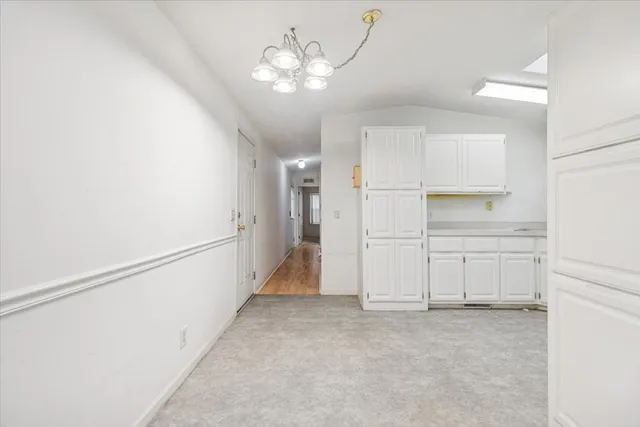 a view of a kitchen with a sink and cabinets