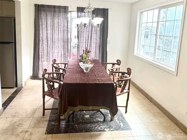 a view of a dining room with furniture and window