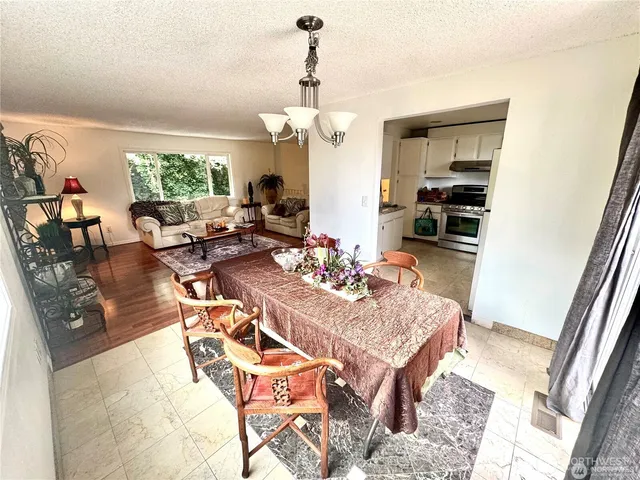 a living room with furniture a window and a chandelier