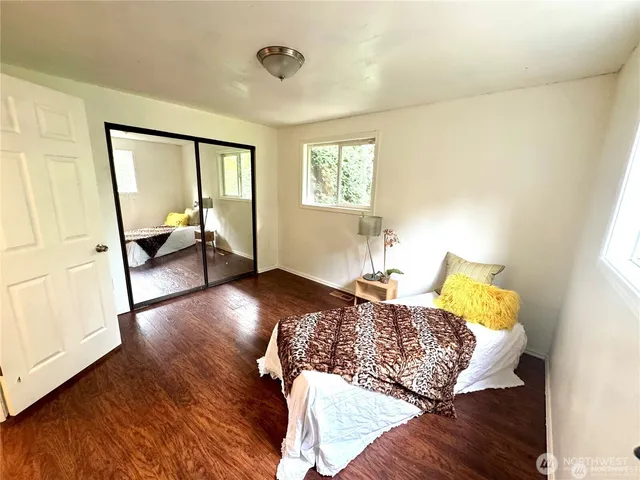 a bed sitting in a bedroom next to a window