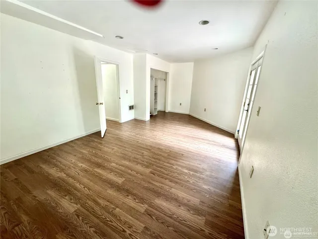a view of a livingroom with wooden floor and entryway
