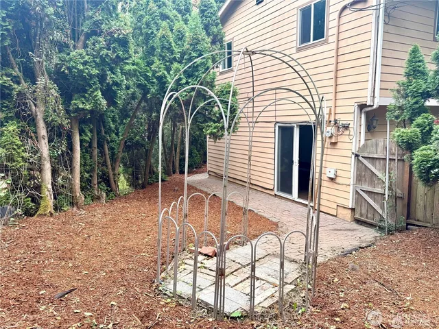 a view of house with backyard space and seating area