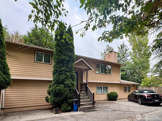 a front view of a house with a garden