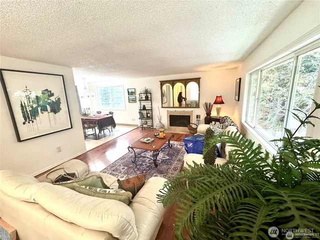 a living room with furniture large window and a flat screen tv