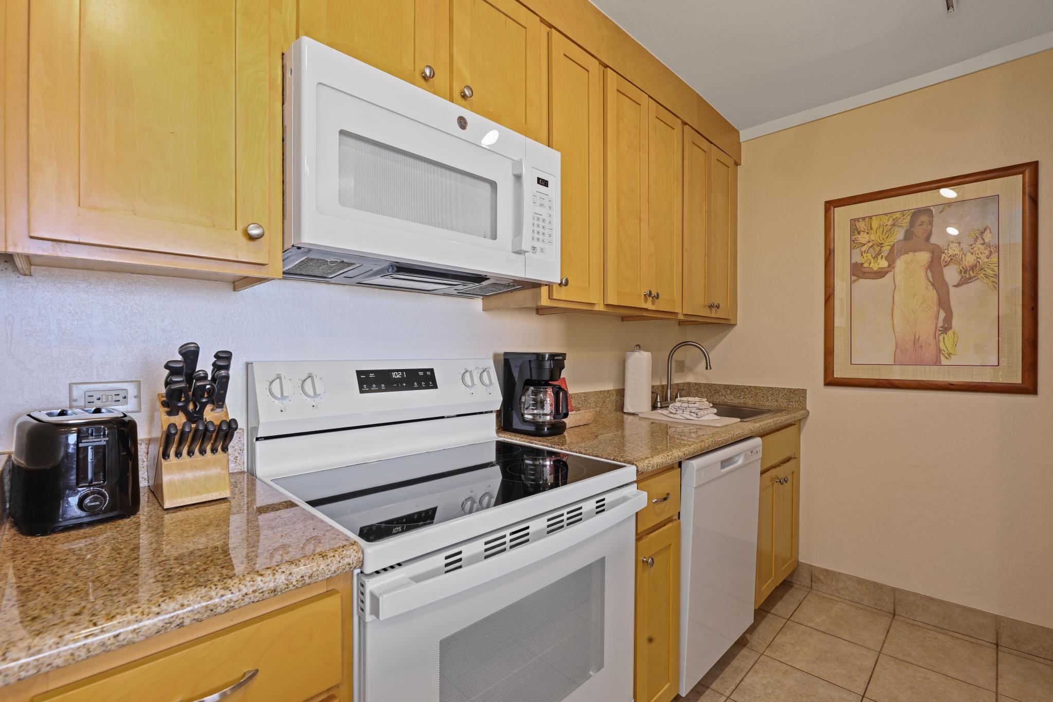 3445 Lower Honoapiilani Road, Unit 727 Lahaina, HI 96761 - Photo 11 of 42 a kitchen with stainless steel appliances granite countertop a sink stove and cabinets