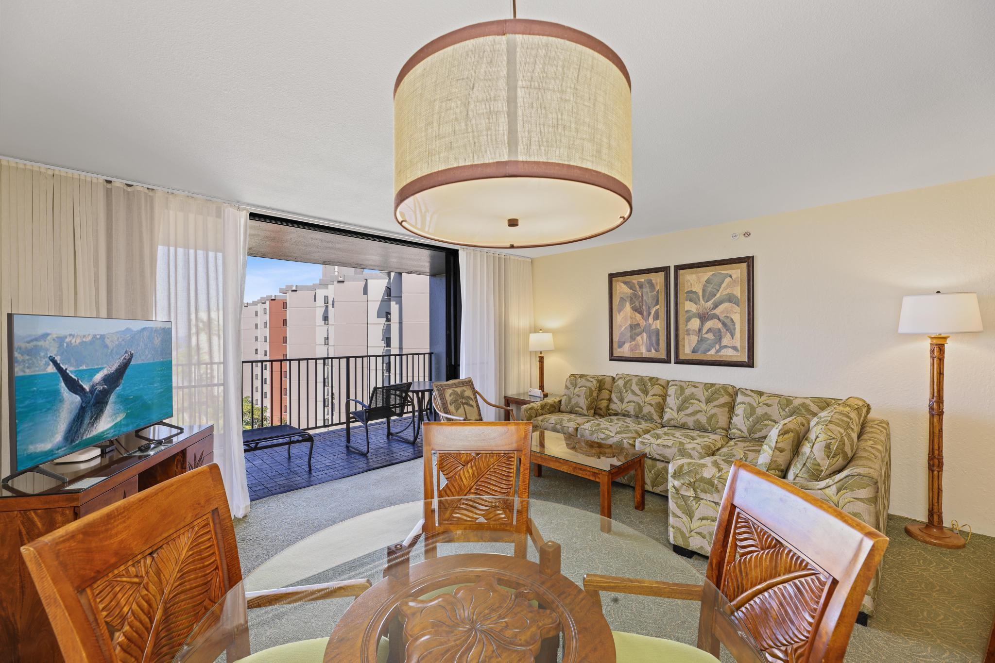 3445 Lower Honoapiilani Road, Unit 727 Lahaina, HI 96761 - Photo 12 of 42 a living room with furniture a flat screen tv and a window